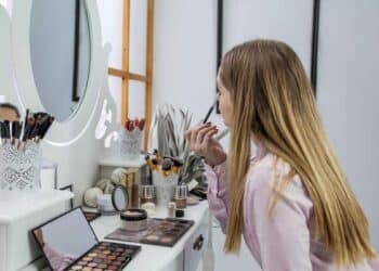 Looking herself into the mirror and doing her make-up