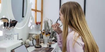 Looking herself into the mirror and doing her make-up